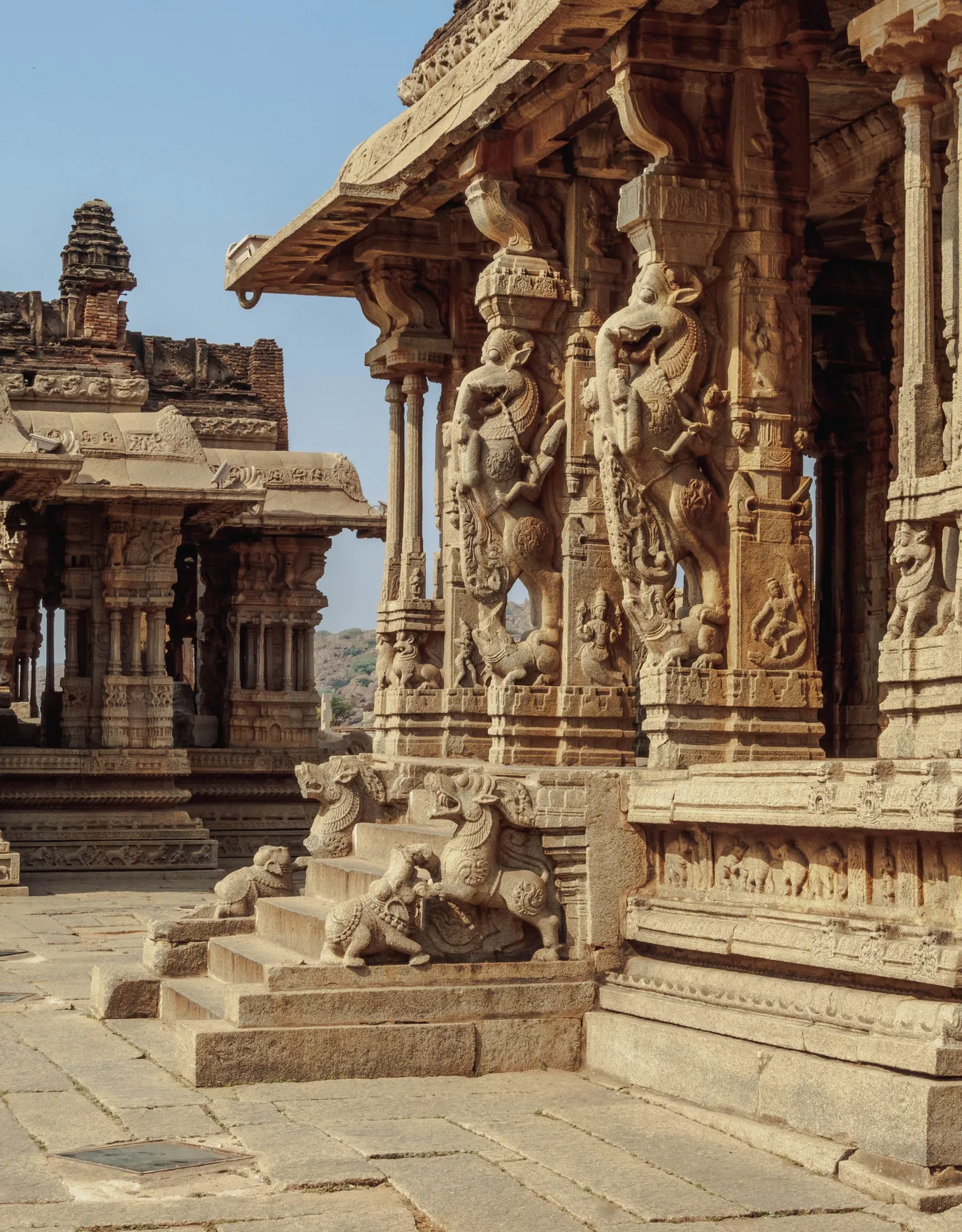 Carved stone temple architecture in South Asia — ornate pillars and colonnade.